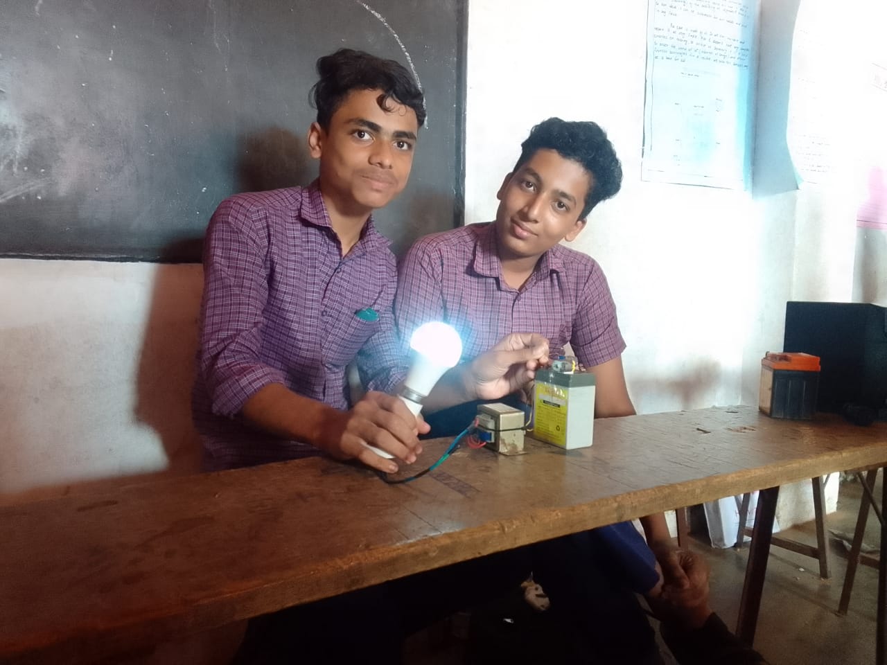 Sajad with his friend Mishal in 2022 during their 10th standard science fair showcasing an inverter prototype they built together as part of their school project.